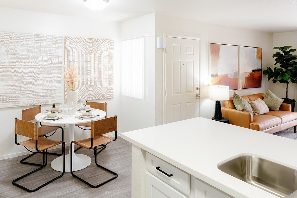 a kitchen and dining room with a table and chairs