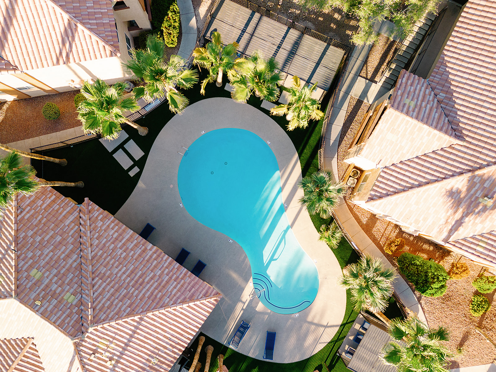 a swimming pool in the middle of a building with palm trees