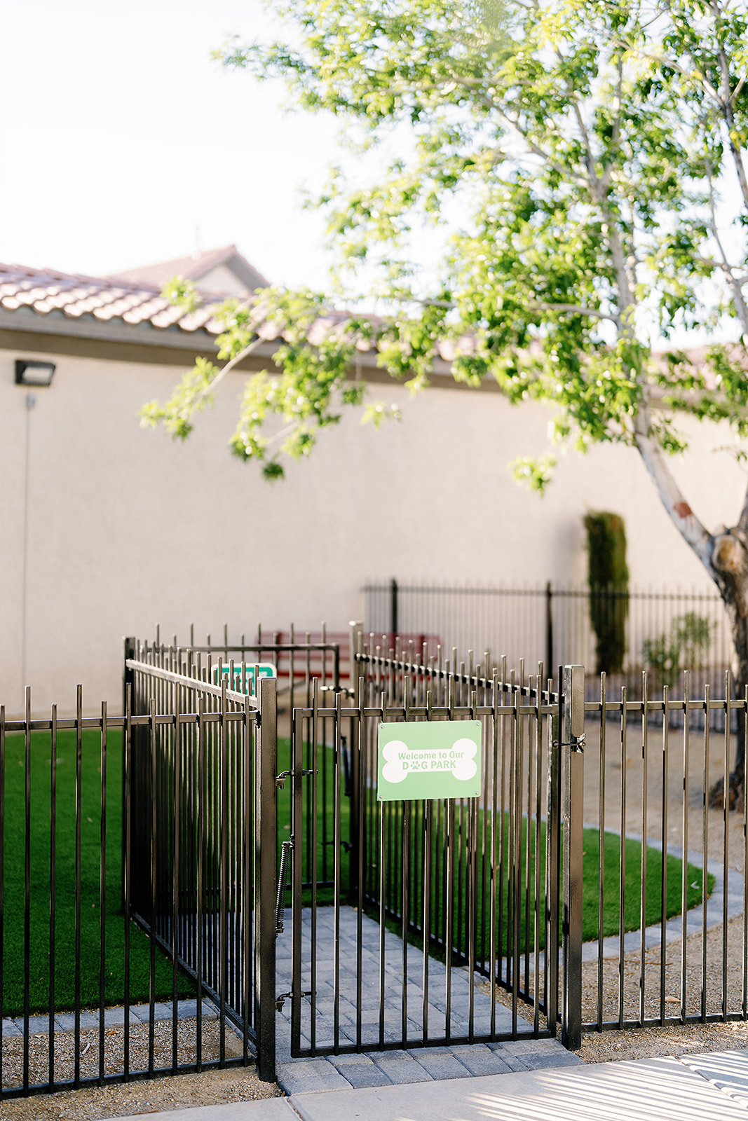 a wrought iron fence surrounds a yard in front of a house