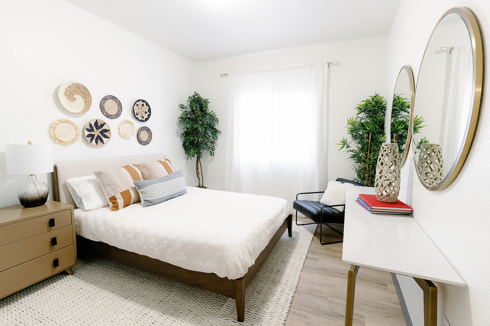 a bedroom with a bed and a dresser and a mirror