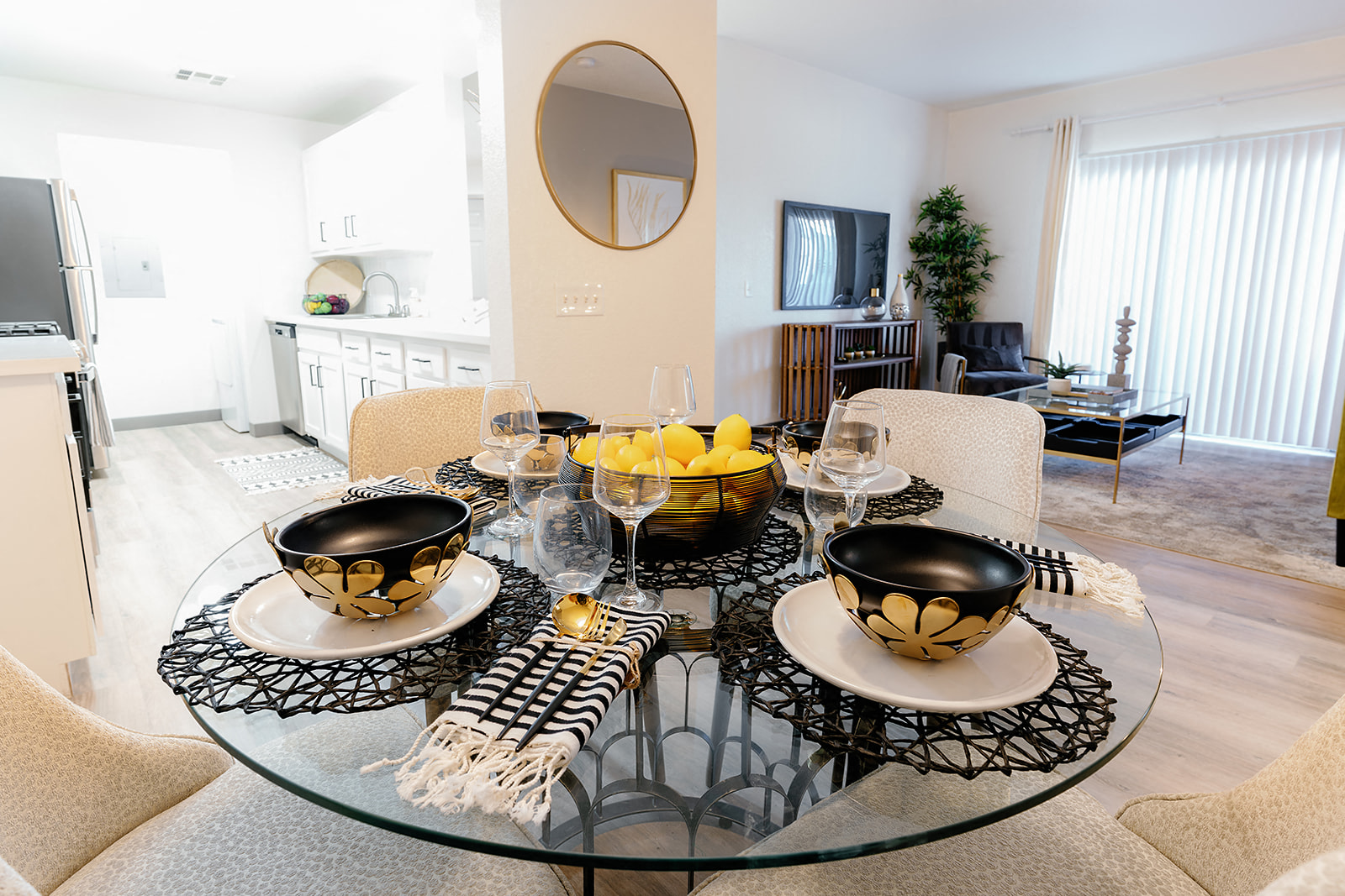 a living room and dining room with a glass table