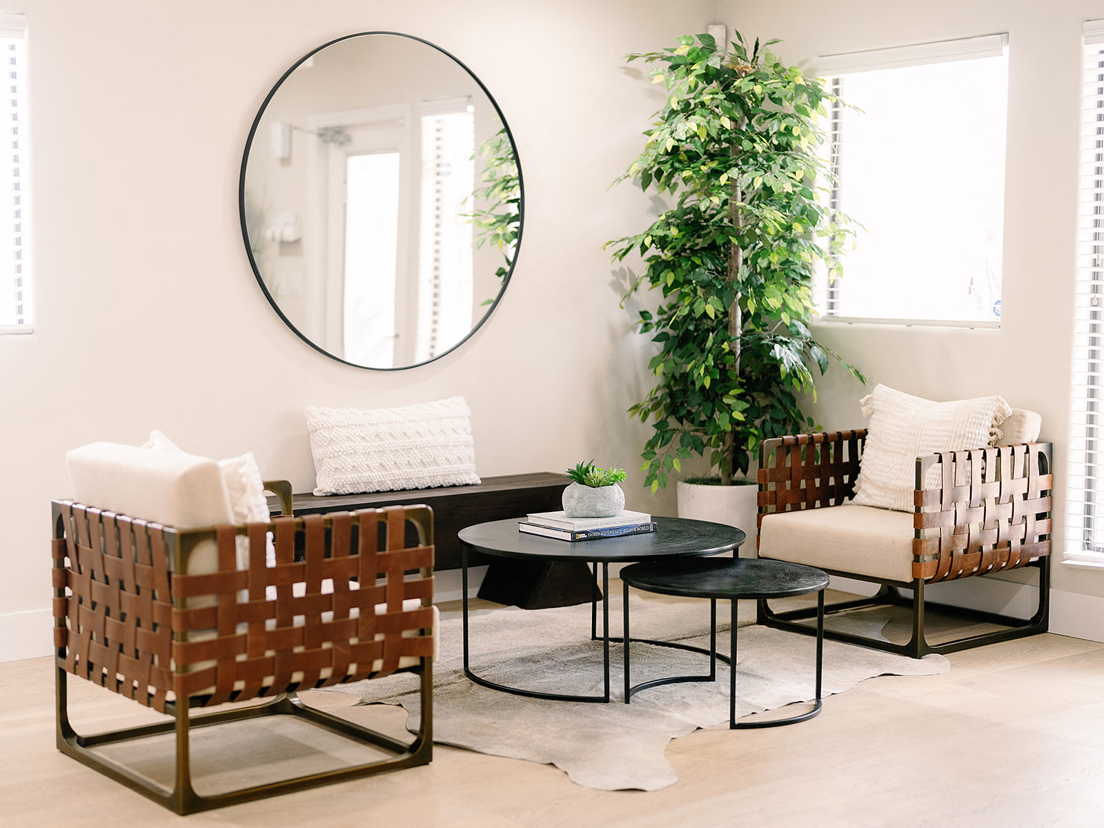a living room with a table and chairs and a mirror
