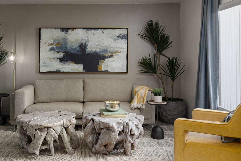 a living room with a couch and tables