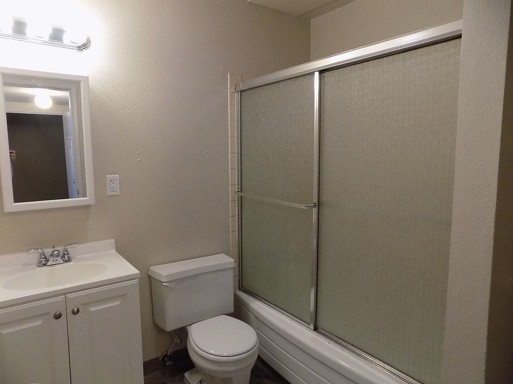 a bathroom with a toilet sink and a shower