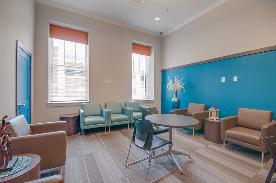 a waiting room at a hospital with chairs and tables