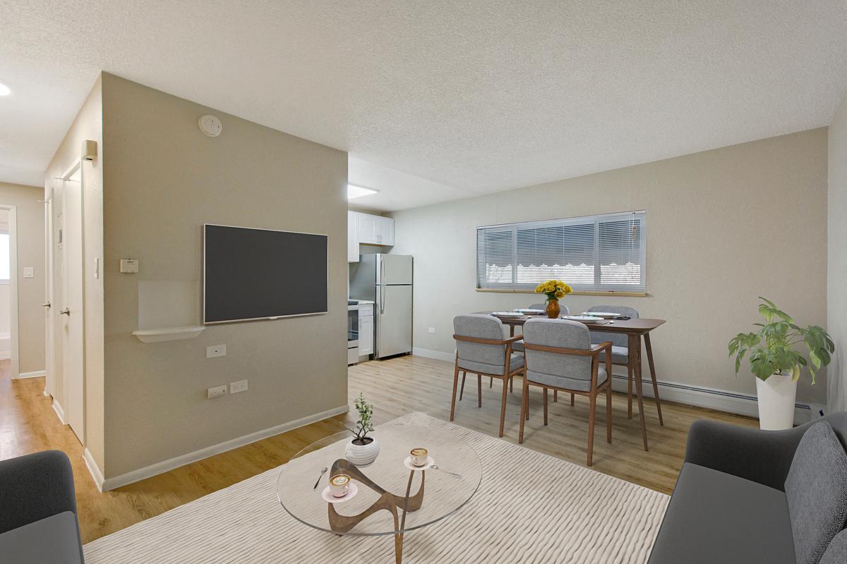 a living room and dining room with a television