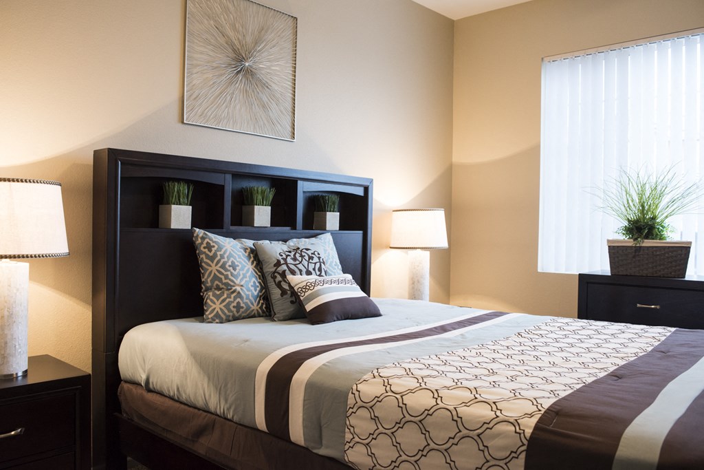 a bedroom with a large bed and a window