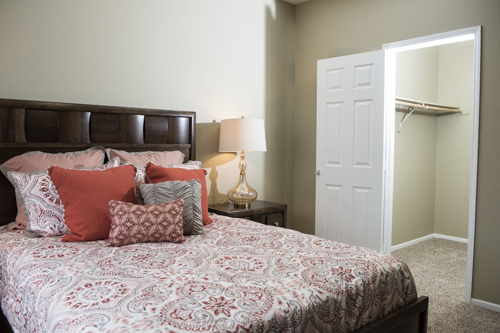 a bedroom with a bed and a closet