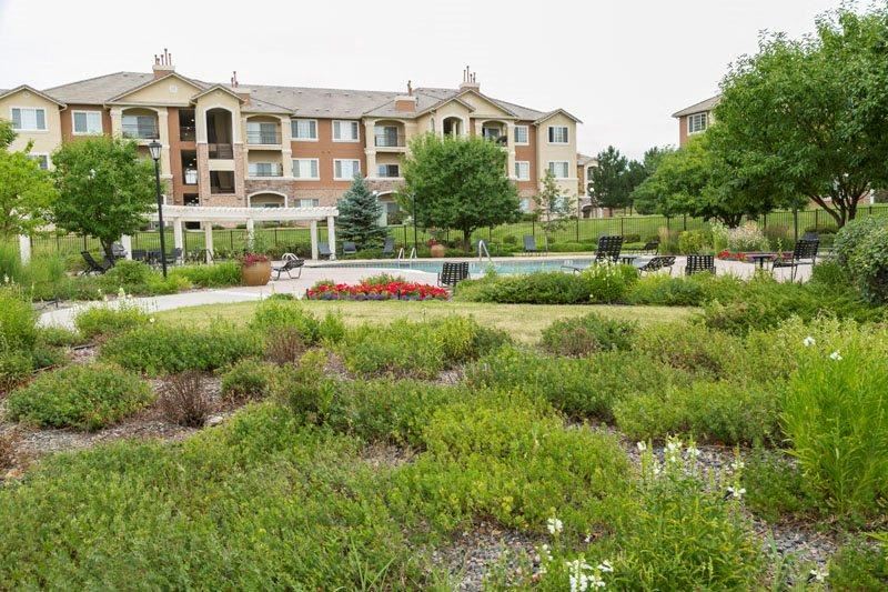 a garden in front of an apartment building
