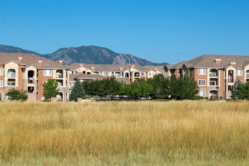 an empty field in front of an apartment building