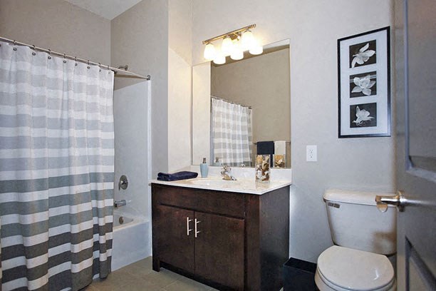 a bathroom with a toilet and a sink and a shower