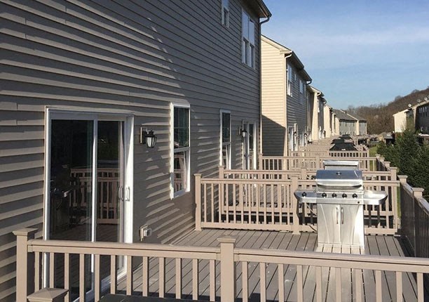 a house with a grill on a deck