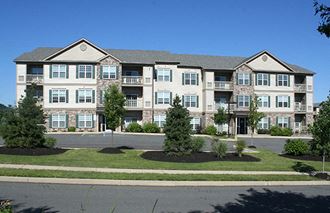 an exterior view of an apartment building on a city street