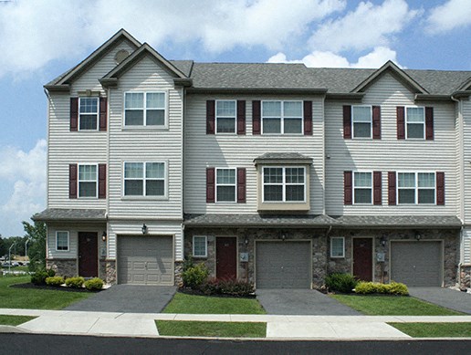 a house with two garage doors and a lawn