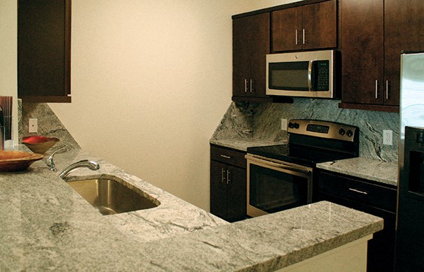 a kitchen with granite counter tops and a sink