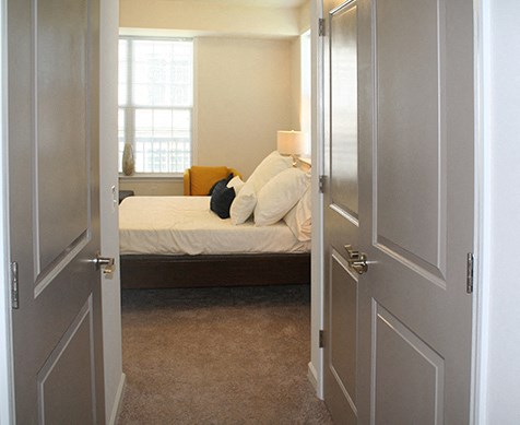 a bedroom with a bed and a door open to it
