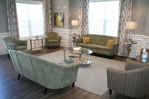 a living room with couches and chairs