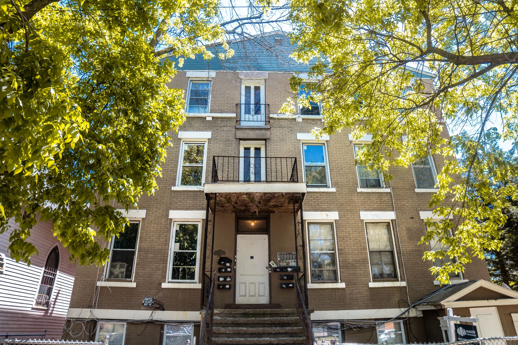 A brown building with a white door and windows.