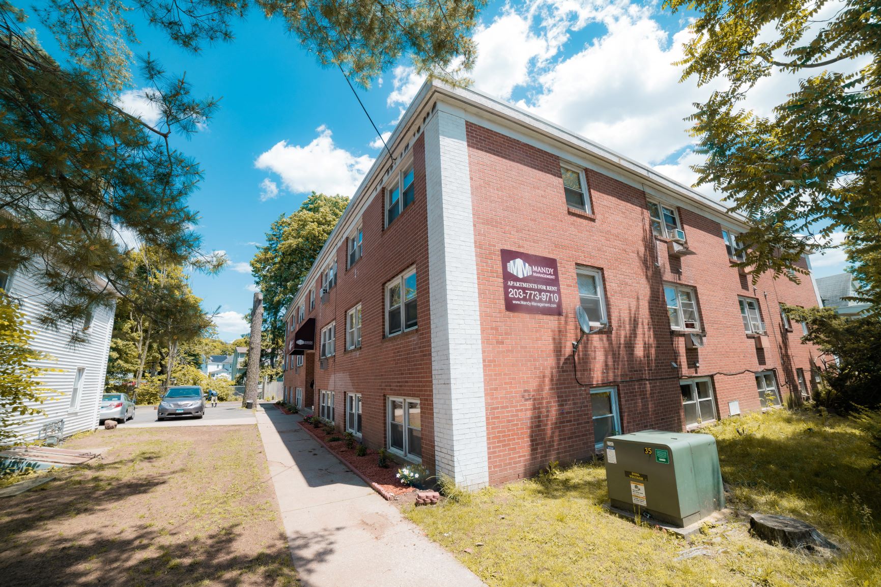 A red brick building with a sign on it.