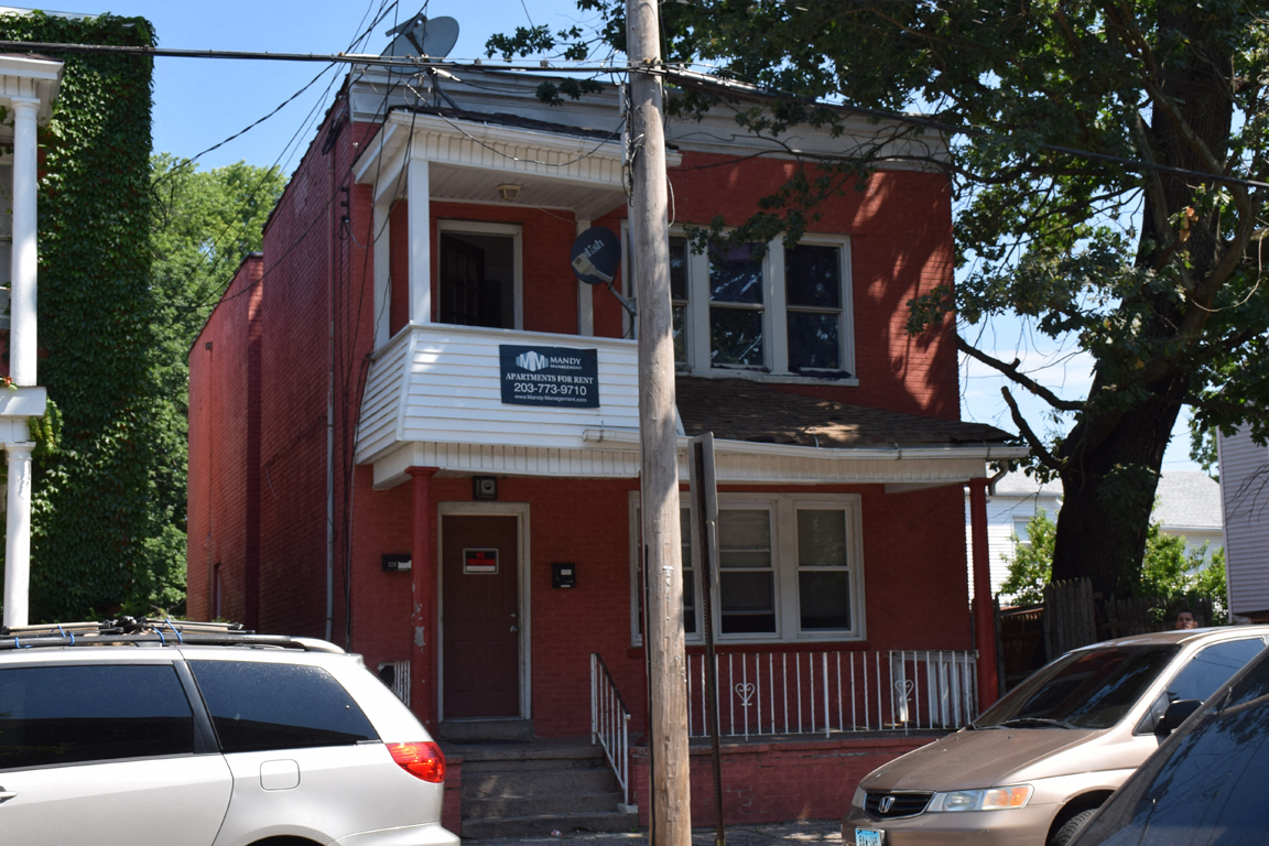 A red building with a white sign on the front.