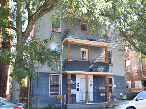 A two-story house with a blue exterior and a white door.