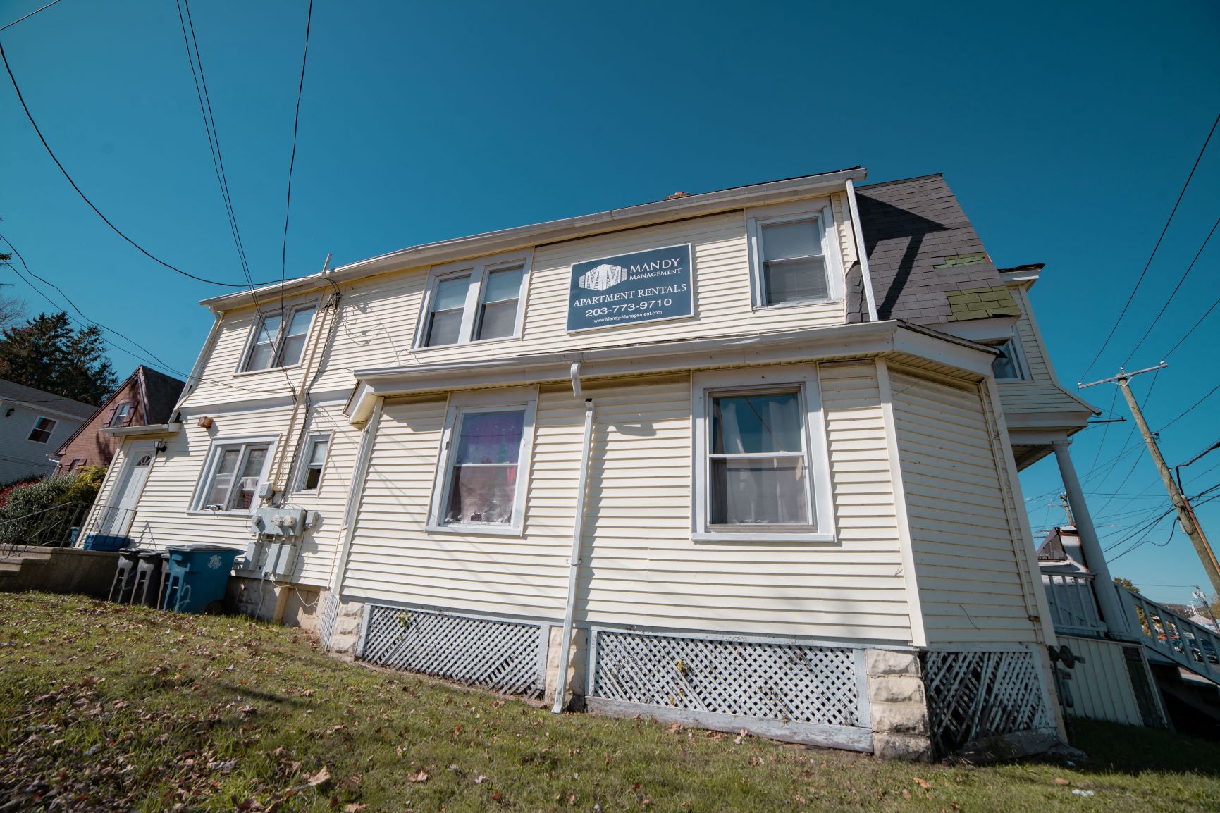 A two-story house with a sign that says "Mandi" on the front.