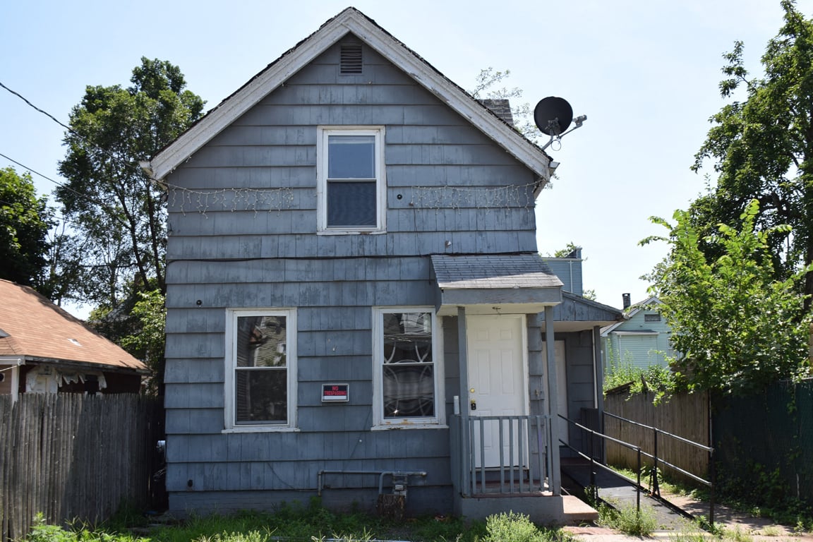 A small house with a satellite dish on the roof.