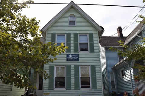 A house with a sign that says "SOLD" on it.
