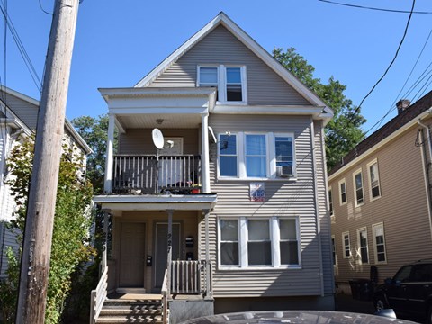 A two-story house with a balcony on the second floor.
