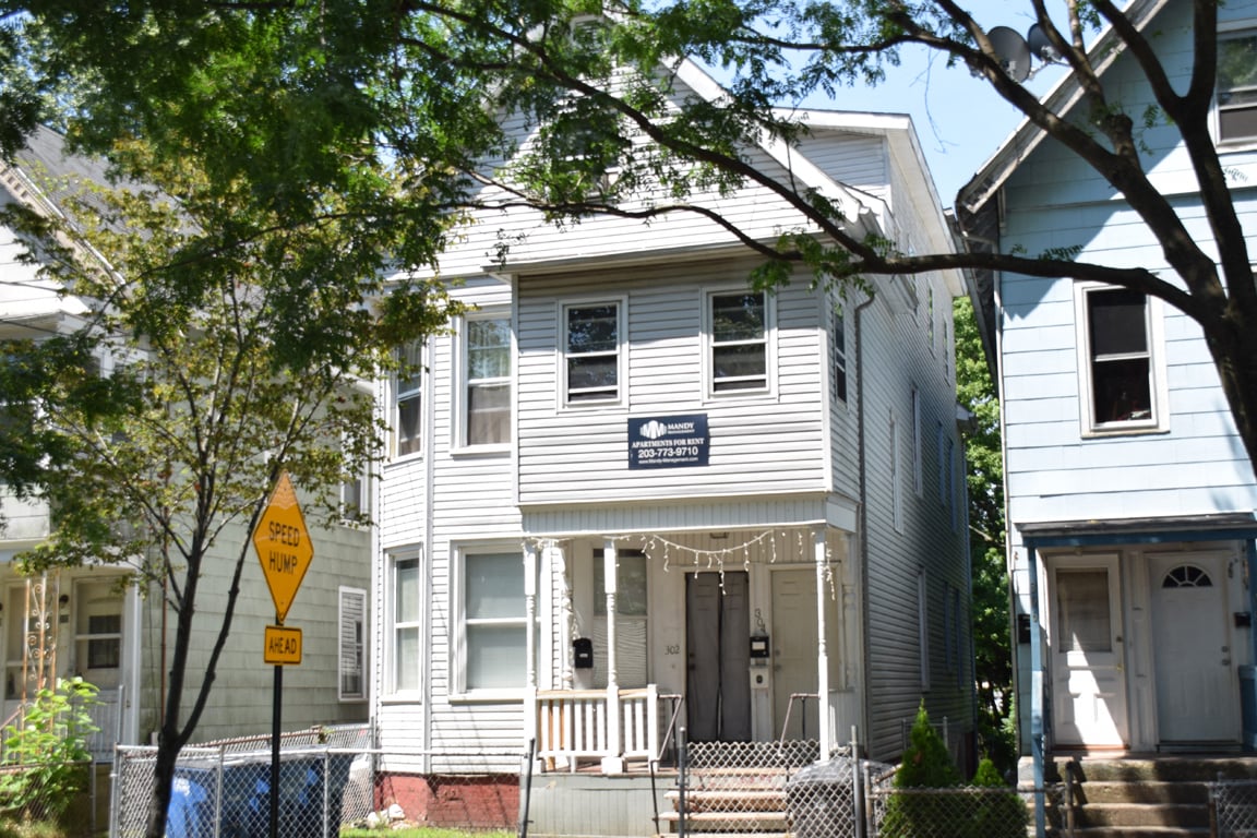 A house with a sign that says "No Parking" in front of it.