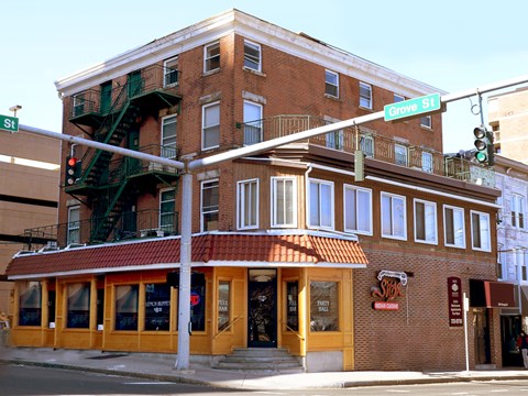 A building with a red awning and a sign that says "Smokehouse" is on Grove St.