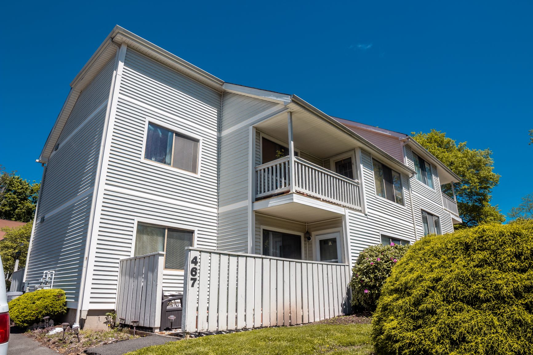 A two-story residential building with a garage.
