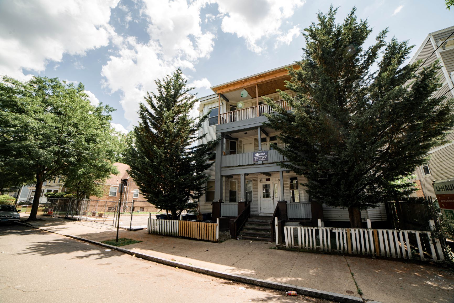 A two-story house with a balcony and a porch.
