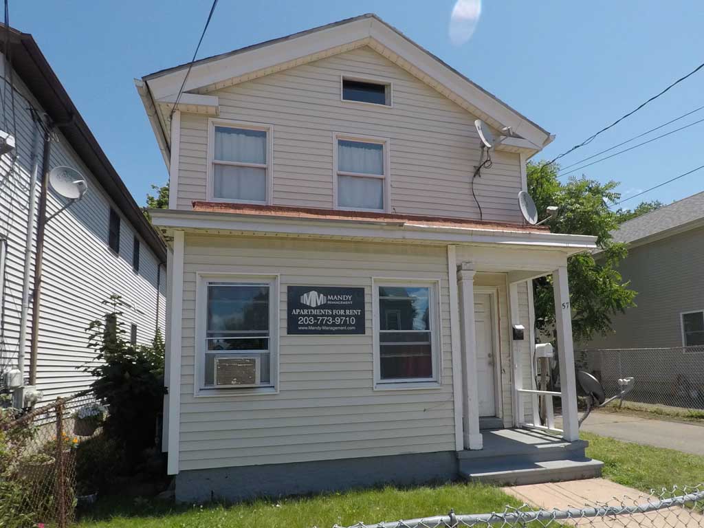 A two-story house with a sign that says "BASKETBALL APARTMENTS FOR RENT".