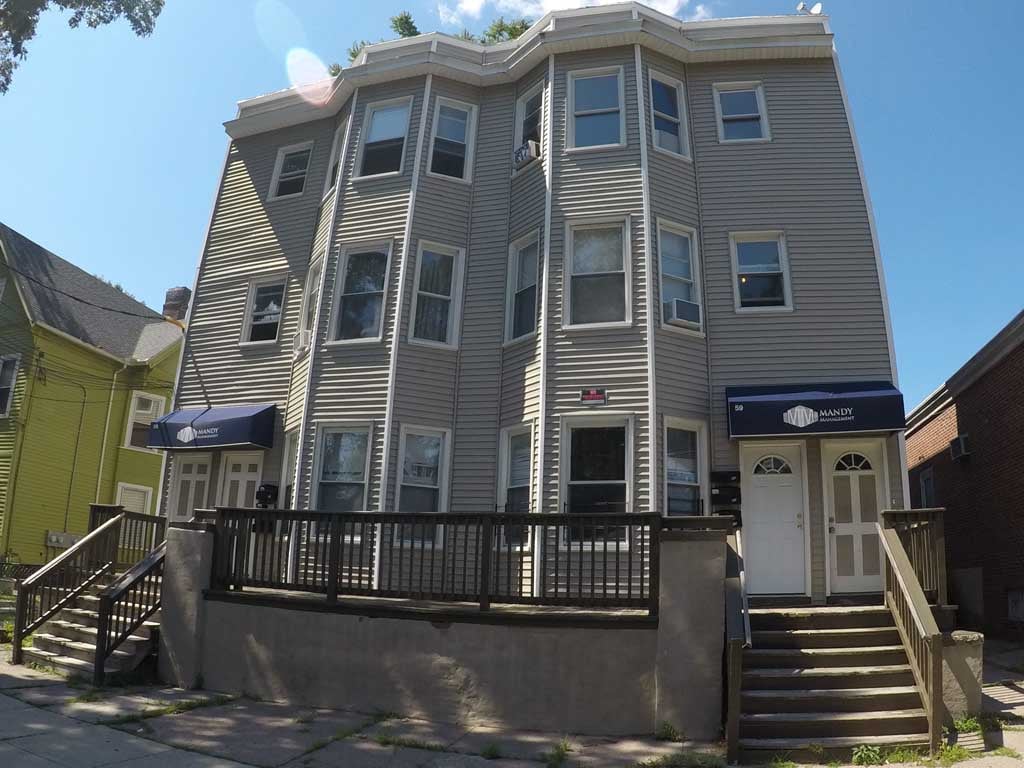 A building with a blue awning and a white door.