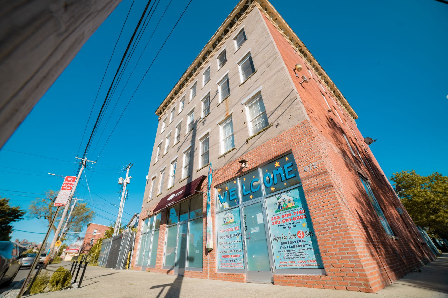 A brick building with a blue sign on the front.
