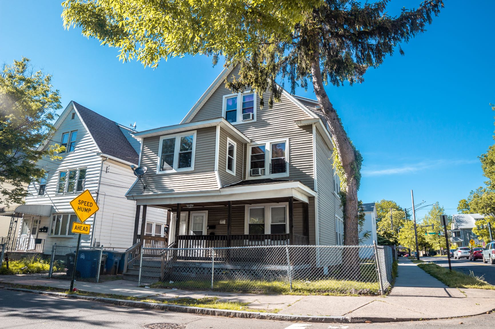 A house with a yellow sign in front of it.