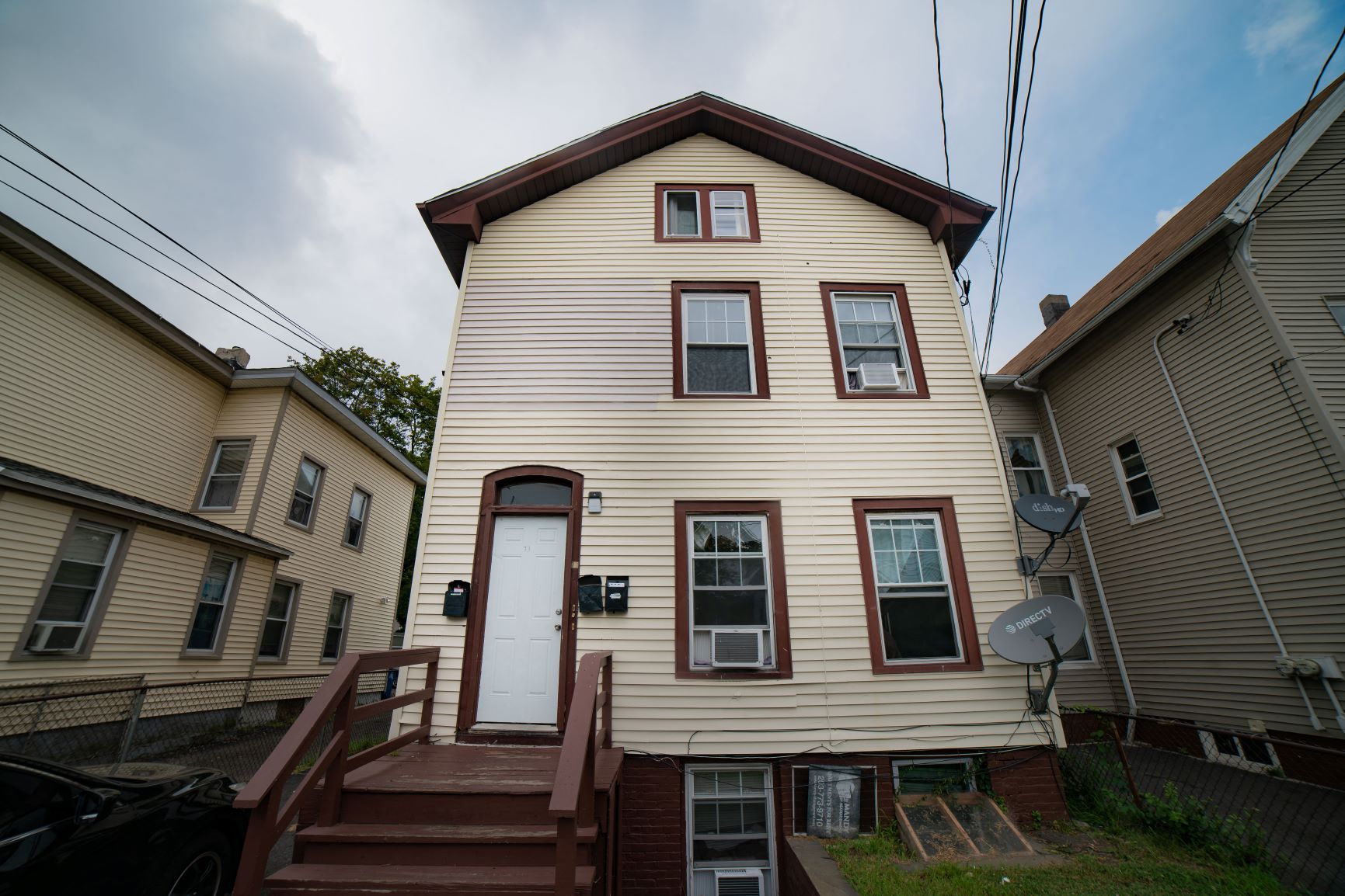 A house with a white door and brown steps.