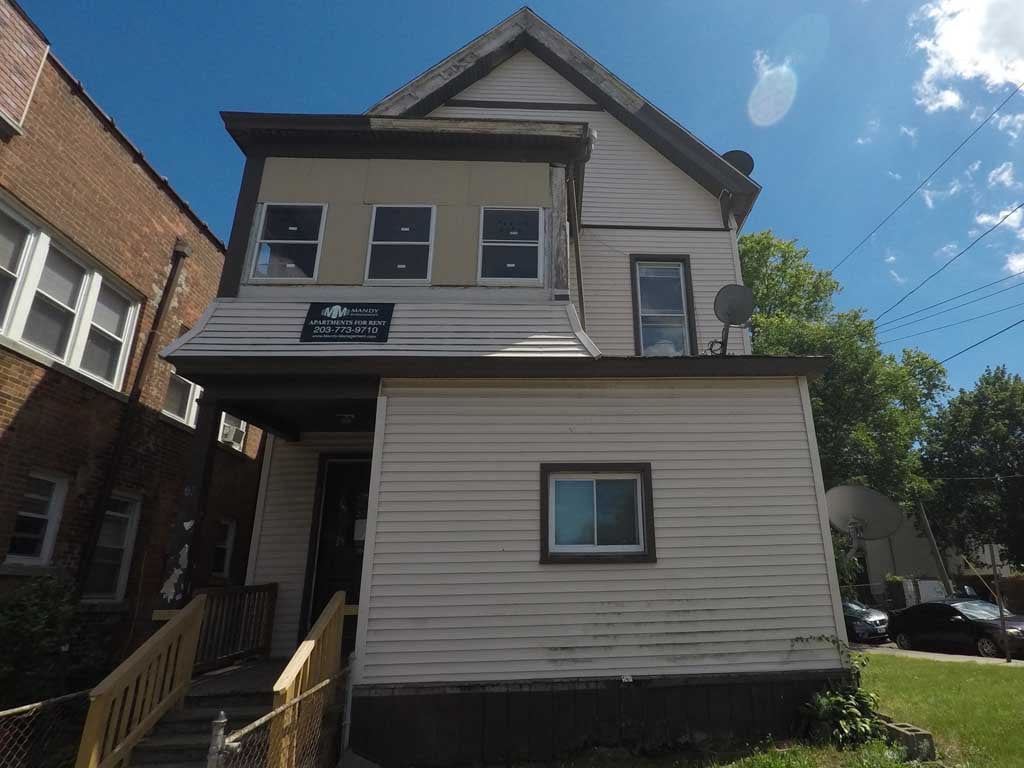 A house with a satellite dish on the roof.