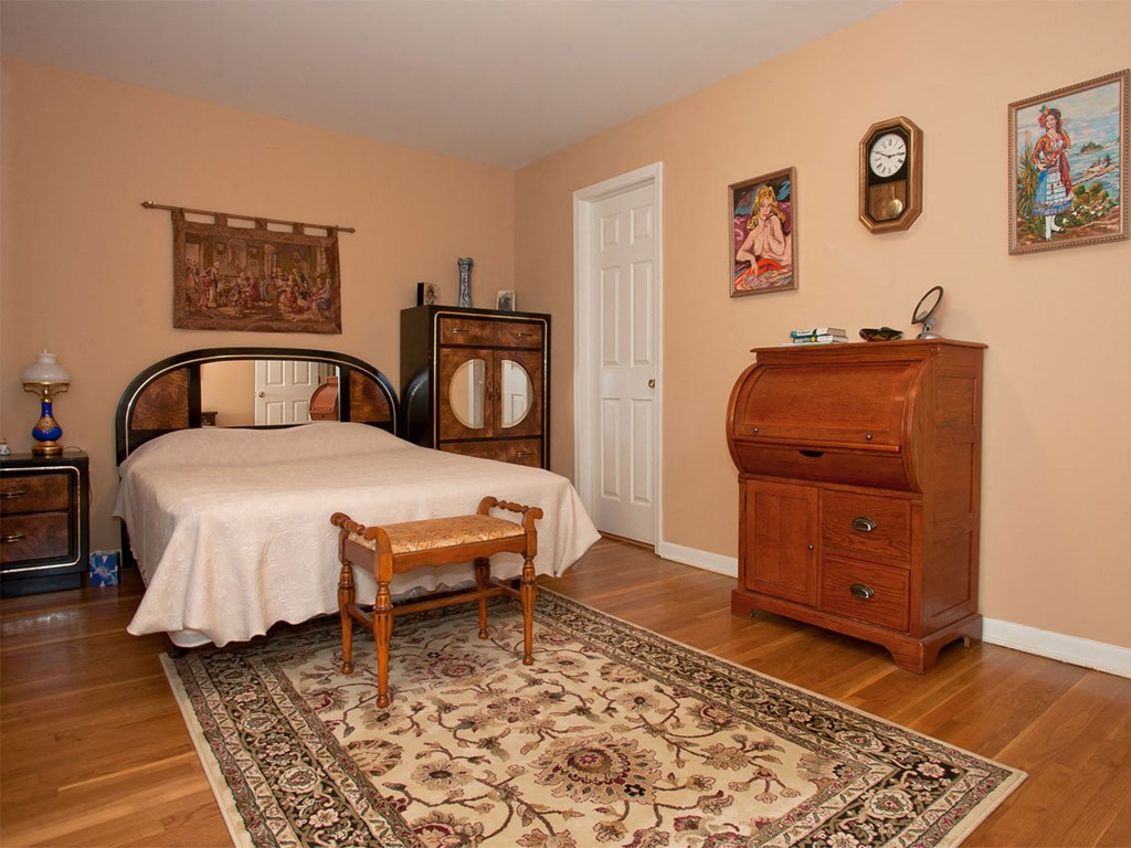 a bedroom with a bed and a dresser