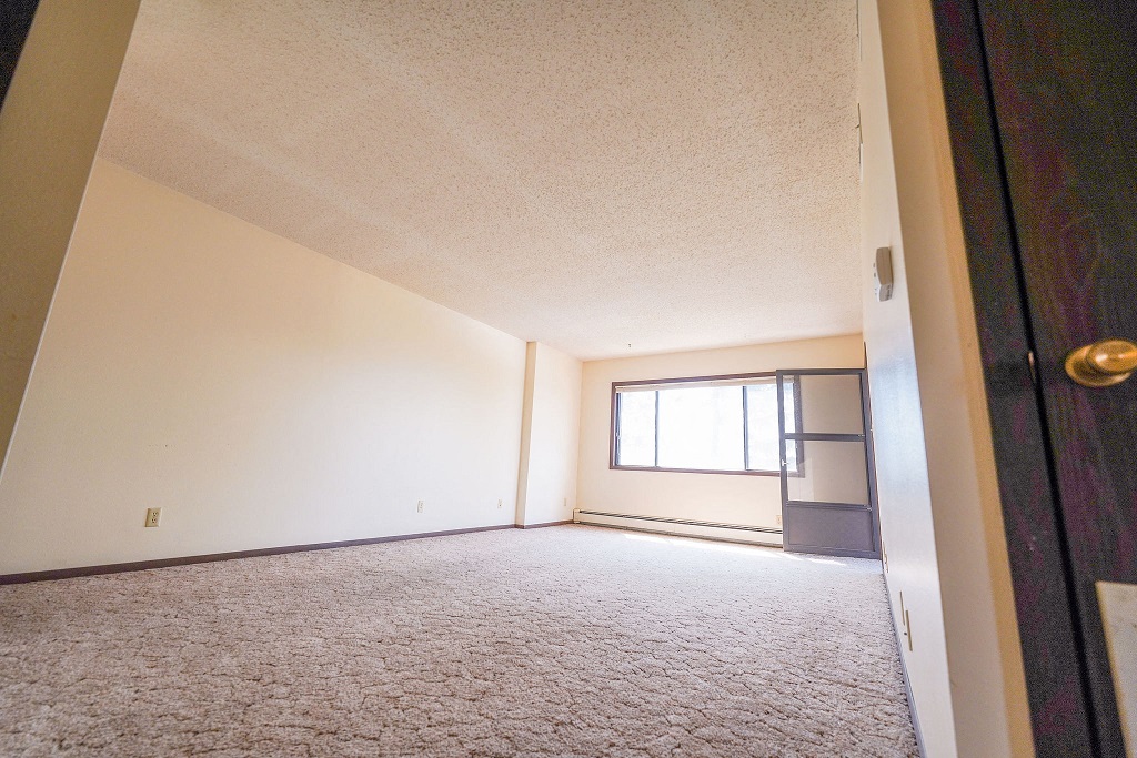 the living room of an empty house with a window