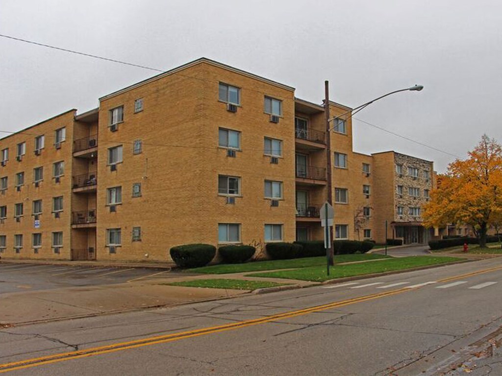a brick apartment building on the corner of a street