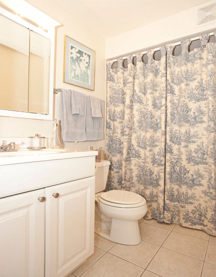 a bathroom with a toilet and a shower curtain