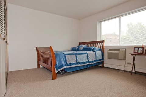 a bedroom with a bed and a window