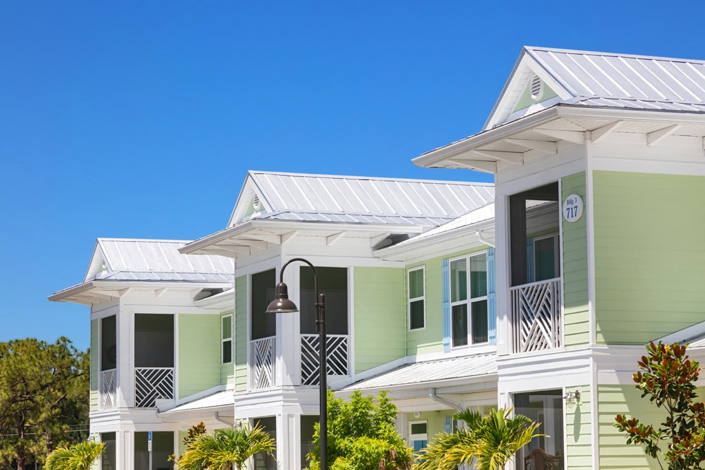 a row of houses with green and white roofs