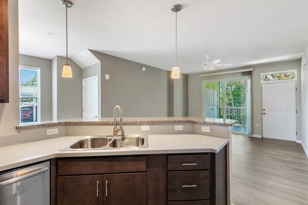 the kitchen and living room of a new home