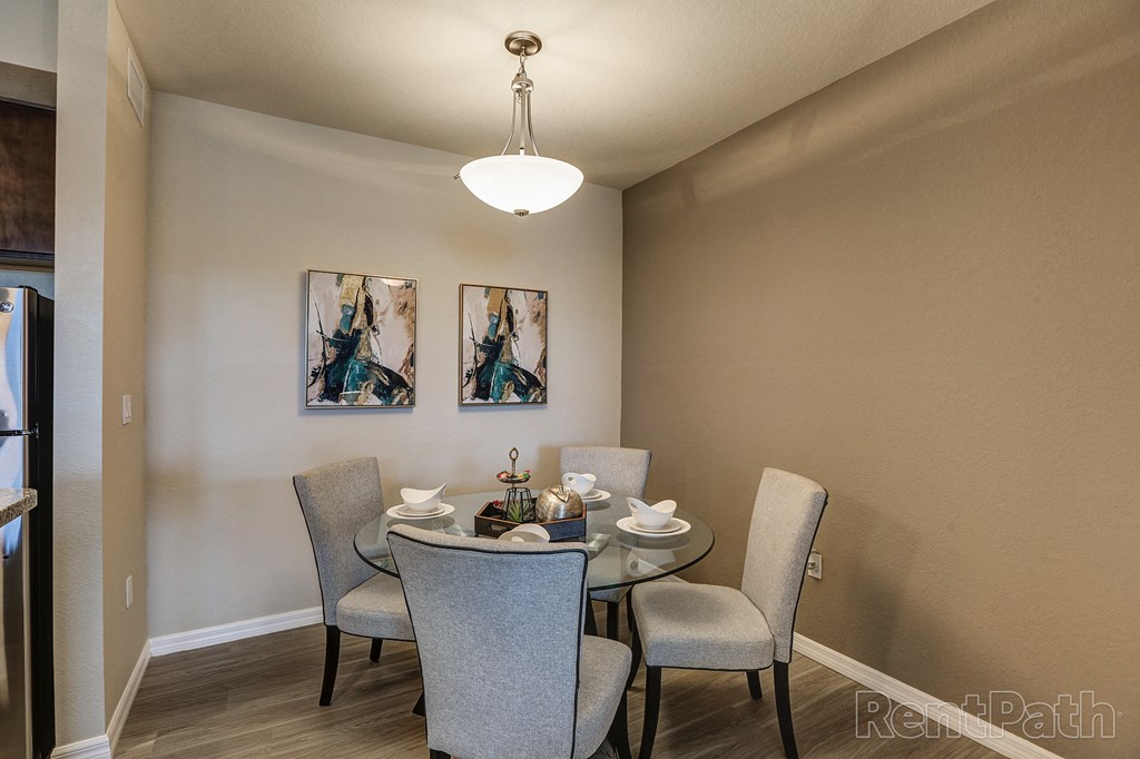 a dining room with a table and chairs and a chandelier