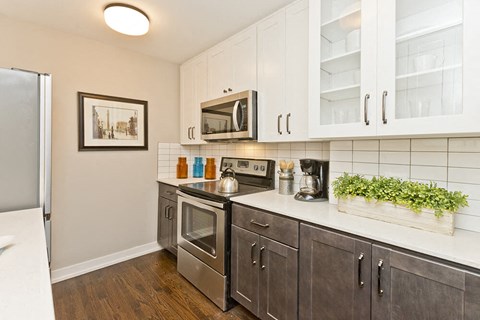 a kitchen with stainless steel appliances and white cabinets