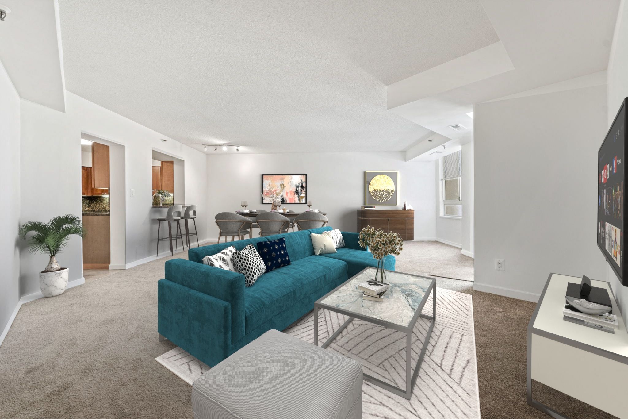 a living room with a blue couch and a table