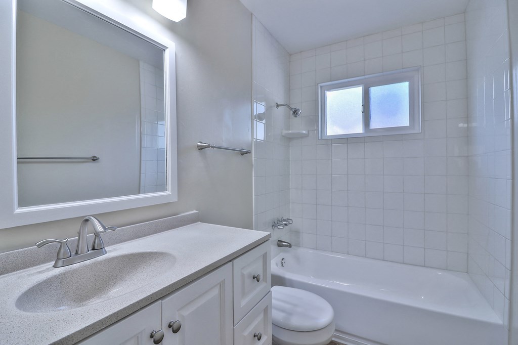 an empty bathroom with a sink and a toilet and a tub